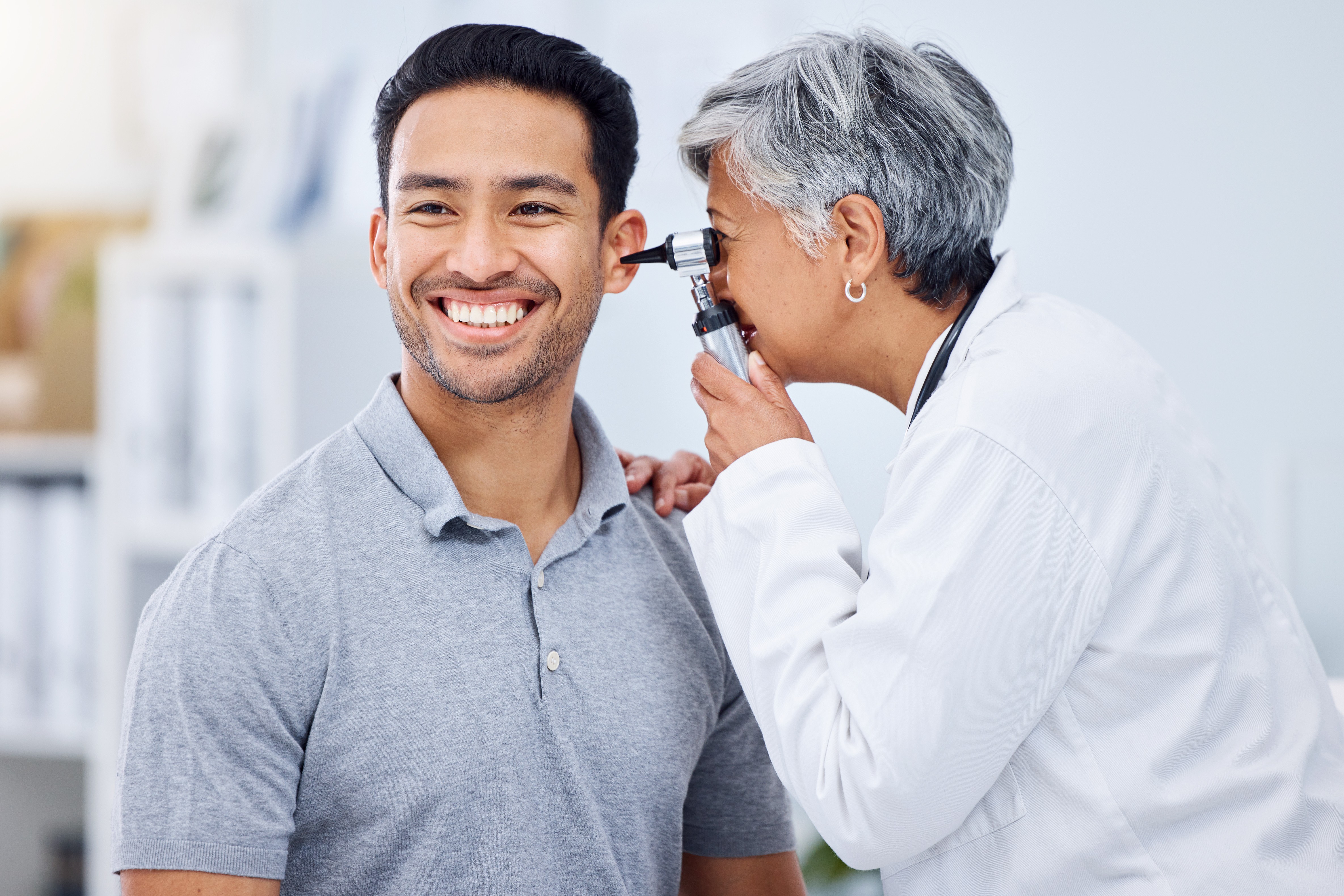 Doctor, patient or ear check for healthcare or wellness at hospital with otolaryngology specialist